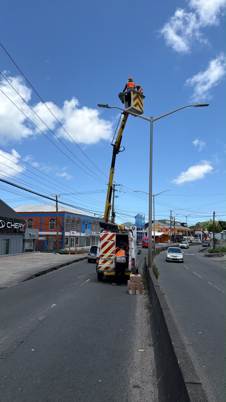 KLED crew working at a streetlight from a cherry picker, viewed along the dual carriageway.